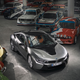 A photo of a BMW i8 coupe in a room full of vintage BMW cars.